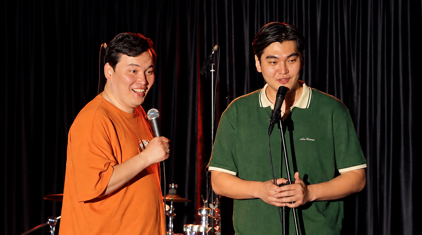 Two Good Night Comedy comedians performing stand-up on stage in Almaty