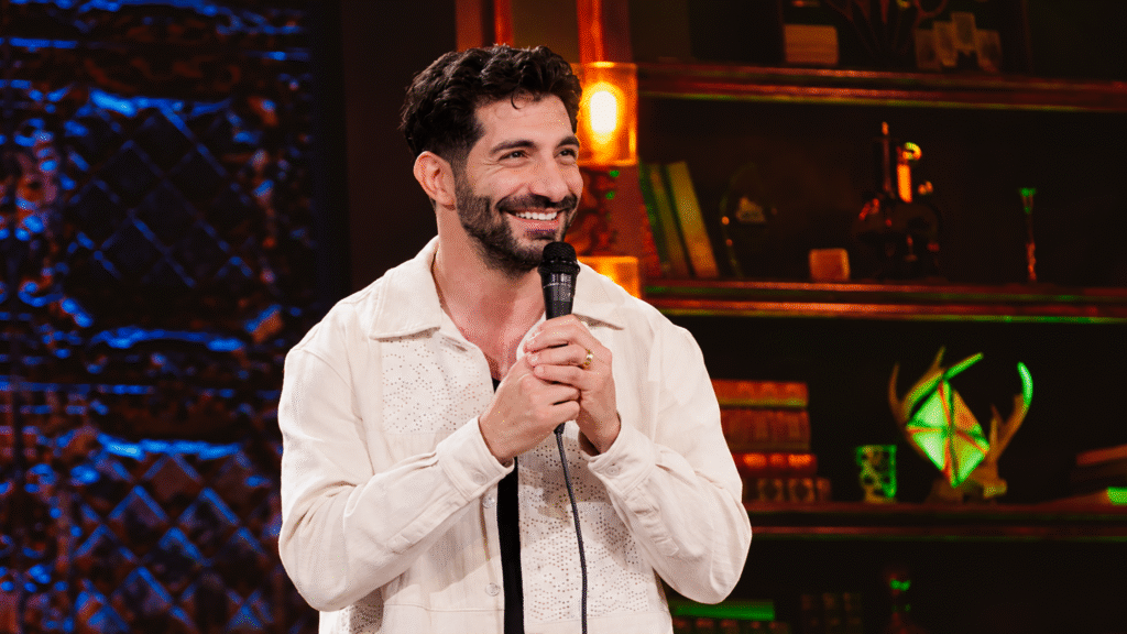 Paul Elia performing stand-up on stage