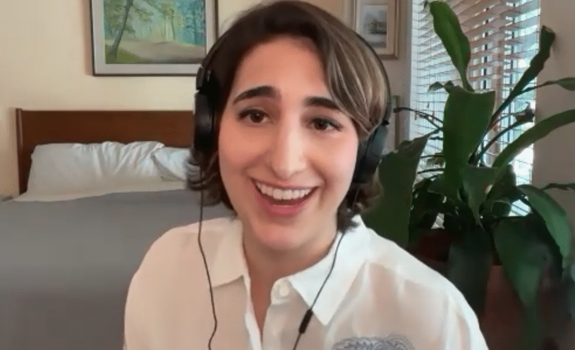 Marina di Marzo laughing in headphones during her interview