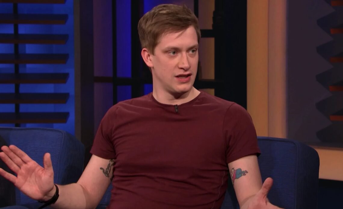 Daniel Sloss in a maroon T-shirt during a talk show interview