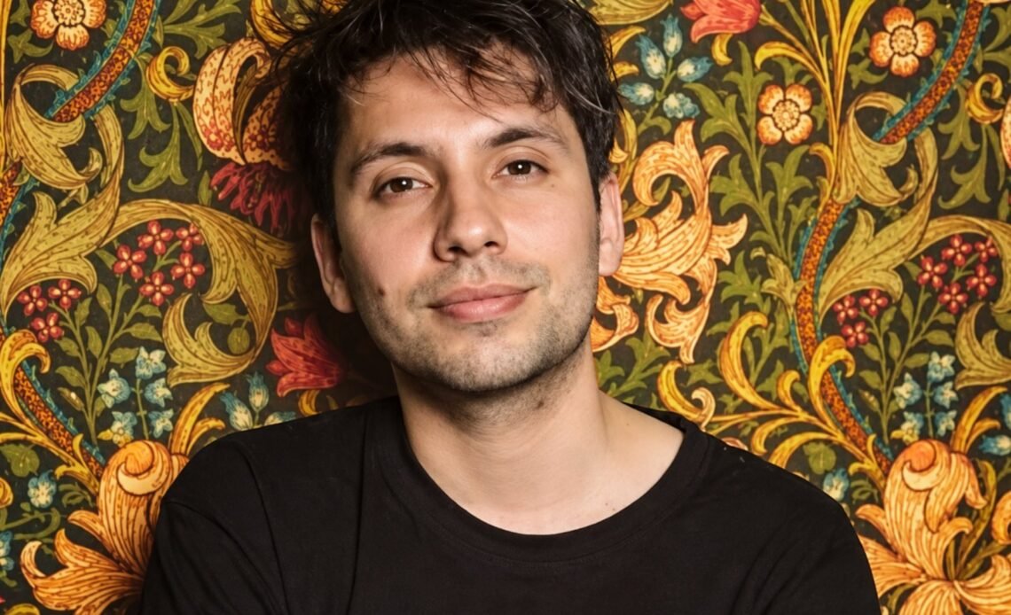 Portrait of Fabrizio Copano against floral wallpaper