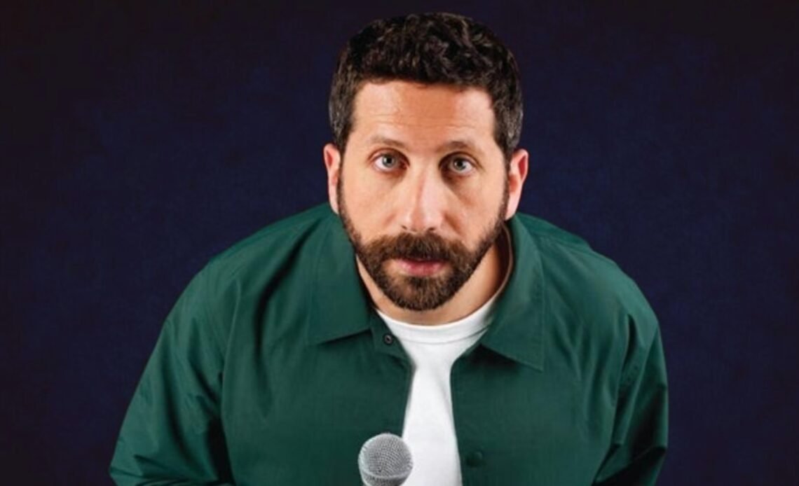 John Achkar holding a microphone