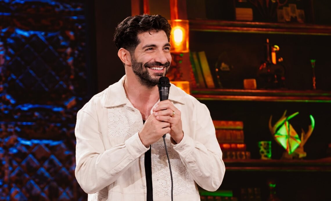 Paul Elia performing stand-up on stage
